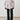 Person wearing a light pink blazer and black pants against a white background