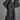 Person wearing a long dark gray trench coat against a plain background